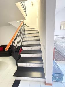 a staircase in a house with black and white floors at Happy Haven al mare in Riviera in Chiavari