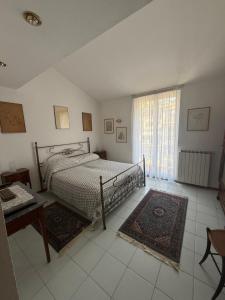 a bedroom with a bed and a table and a window at Happy Haven al mare in Riviera in Chiavari