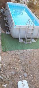 a pool with a slide and two chairs next to it at Sara in Nîmes