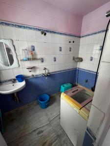 a bathroom with a sink and a toilet and a sink at Subba Stays in Siliguri