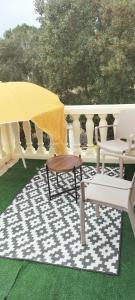 a patio with a table and two chairs and a rug at Sara in Nîmes
