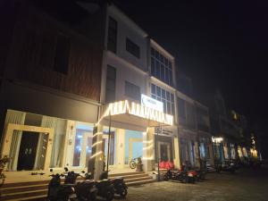 a group of motorcycles parked outside of a building at night at Moonrise Rooms in Uluwatu