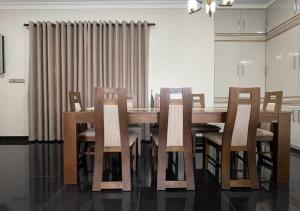 a dining room with a wooden table and chairs at Palm Breeze Villa in Mannar +9 photos