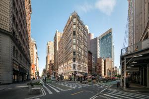 an empty city street with a tall building at Flatiron Studio Near Madison Square Park in New York