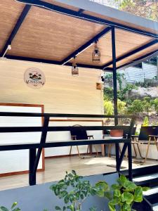 a patio with a bench and a table at Chalok Garden bungalow in Ko Tao