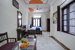 a room with a dining table and a bedroom at Hotel Prithvi Studio - RDC And Santosh Hospital in Ghaziabad
