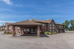 a brick building with a pavilion in a parking lot at Comfort Inn Sydney - Cape Breton in Sydney