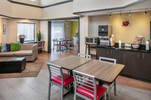 a kitchen and living room with a table and chairs at Comfort Inn Sydney - Cape Breton in Sydney