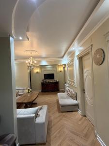 a living room with a couch and a table at Warm Flat in Gonio