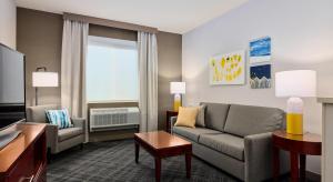 a living room with a couch and a table at Comfort Suites Springfield-Eugene in Springfield