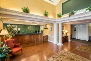 a lobby with a waiting area with a red chair at Quality Inn Greeneville - Tusculum in Greeneville