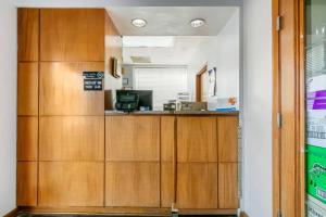 a room with wooden cabinets and a desk at Rodeway Inn Kingston Springs in Kingston Springs