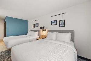 two beds in a hotel room with white sheets at Sleep Inn & Suites Verona - Madison Southwest in Verona