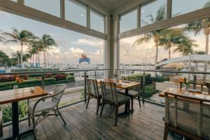 a restaurant with tables and chairs and a view of the water at Hilton Key West Resort & Marina in Key West