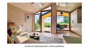 a living room with a couch and a table at 110 Tiny House mit traumhaftem Blick über die Wiese in Bleckede