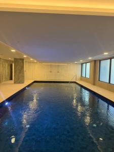 a swimming pool in a building with blue water at New CP Victory suites studio sleeps 4 with pool and gym in Gibraltar