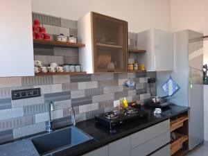 a kitchen with a sink and a counter top at Journeyman Ocean Deck in Marakkānam
