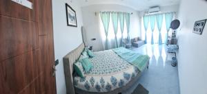 a bedroom with a bed and some windows at Journeyman Ocean Deck in Marakkānam +22 photos
