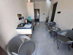a room with chairs and a counter with a table at Journeyman Ocean Deck in Marakkānam