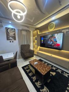 a living room with a couch and a tv at April shortlet apartments in Lagos