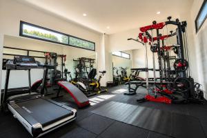 a gym with bikes and tread machines in a room at M&M Hotel in Vang Vieng