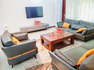 a living room with couches and a coffee table at AWESOME HOME's in Arusha
