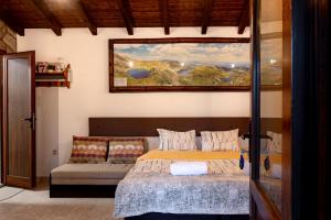 a bedroom with a bed and a couch at Студио Мурите in Sapareva Banya
