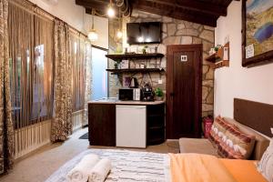 a room with a kitchen with a counter and a refrigerator at Студио Мурите in Sapareva Banya