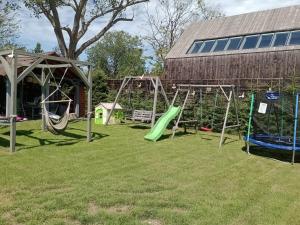 a playground in a yard next to a building at Bałtyckie Siedlisko in Jarosławiec