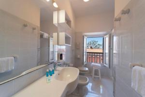 a white bathroom with a sink and a toilet at Residence Hotel Villa Mare in Portoferraio +222 photos