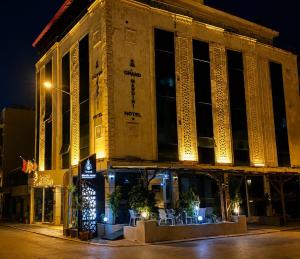 a building on a street at night at Grand Mardin Hotel in Mersin