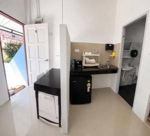 a small kitchen with a black counter and a sink at Yada House Cozy Place in Nai Yang Beach +17 photos