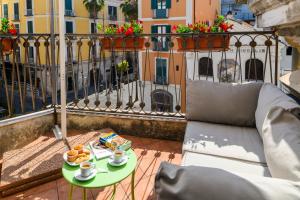 a balcony with a table with food and coffee on it at B&B Portanova in Salerno