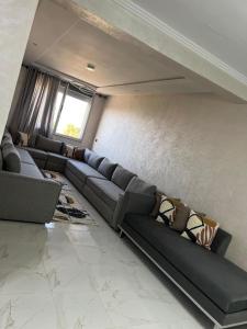 a living room with a couch and a window at nader s in Hajreien