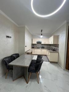 a kitchen with a table and chairs in a room at nader s in Hajreien