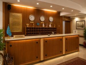 a waiting room with clocks on the wall at Marko Polo Hotel in Aksay
