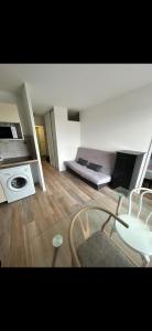 a room with a bed and a table in it at Appartement Ipanema Sud in Canet-en-Roussillon