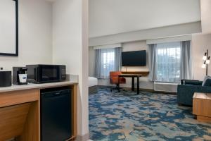a hotel room with a room with a living room at Hampton Inn & Suites Rockland in Thomaston
