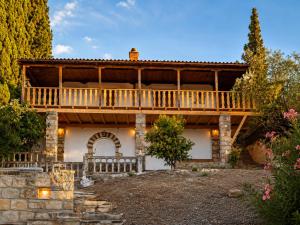 a large house with a deck on top of it at Villa Keren in Oropos