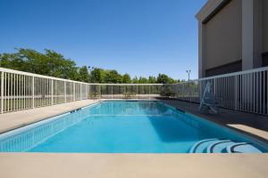a swimming pool with a fence around a building at Hampton Inn Winfield Teays Valley in Teays Valley Estates