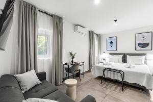 a hotel room with a bed and a couch at Konoba Most Rooms in Buzet