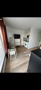 a living room with a table and a kitchen at Appartement Ipanema Sud in Canet-en-Roussillon +6 photos