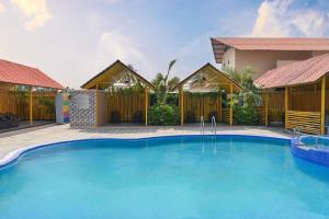 a large swimming pool in front of a house at Enrise By Sayaji Somnath in Somnath