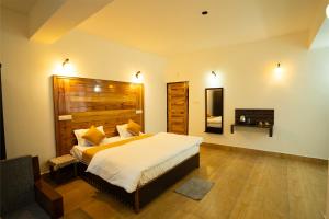 a bedroom with a large bed with a wooden headboard at Twin Garden by TAPSOM in Tādong +126 photos
