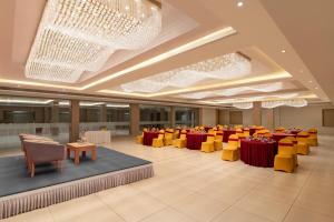 a banquet hall with red and yellow tables and chairs at Enrise By Sayaji Somnath in Somnath +102 photos
