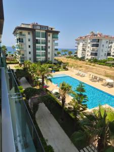 a view of the pool from the balcony of a building at WEDAT APART On the beach Moda Marine Residence in Alanya