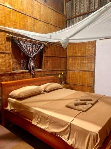 a bed with two towels on it in a bedroom at Phuc Sinh Homestay in Ben Tre
