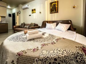 a large bed in a room with a couch at Hotel Nika in Batumi