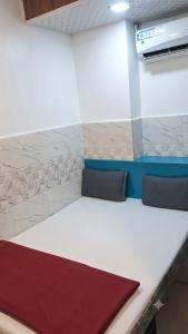 a room with a long white table with two pillows at Hotel firdous in Mumbai