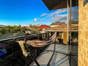 a hammock on the balcony of a house at Hotel Nika in Batumi
